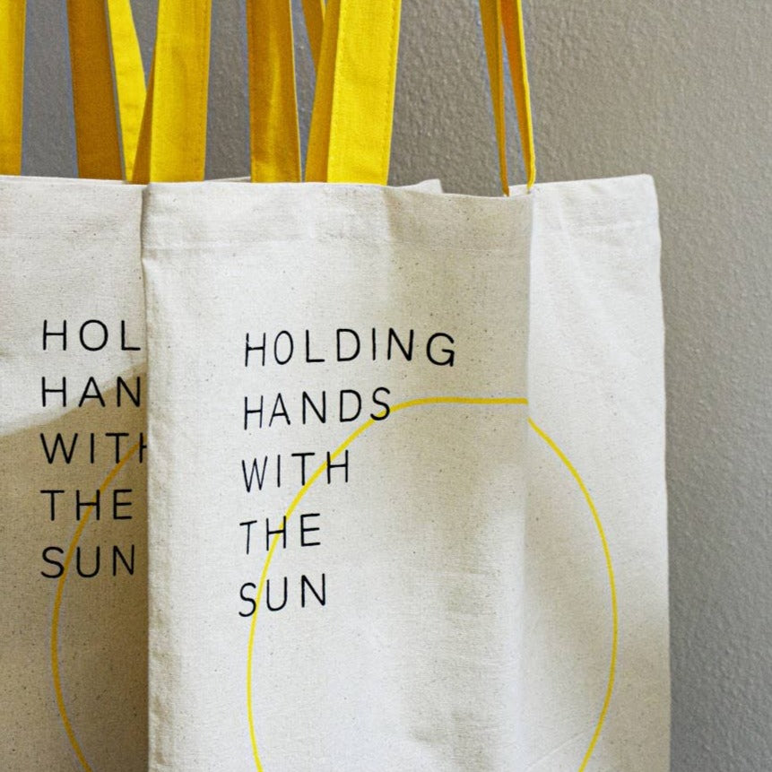 “Holding hands with the sun” Tote Bag